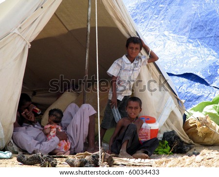HYDERABAD, PAKISTAN - AUG 27: A flood affected family from Jaffarabad rest at a relief camp on August 27, 2010 in Hyderabad.