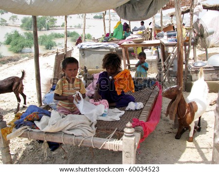 HYDERABAD, PAKISTAN - AUG 27: A flood-affected family from Jaffarabad rest at a relief camp on August 27, 2010 in Hyderabad.