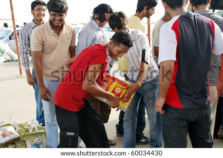 KARACHI, PAKISTAN - AUG 29: Student volunteers help unload and organize relief goods brought by citizens to PAF Base Shahrah-e-Faisal on August 29, 2010 in Karachi.