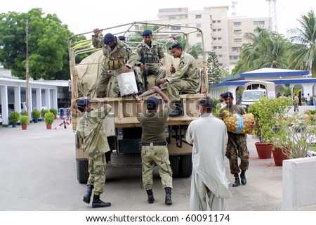KARACHI, PAKISTAN - AUG 30: Relief goods for flood affectees of Sindh being loaded on vehicle by Coast Guard officials on August 30, 2010 in Karachi.
