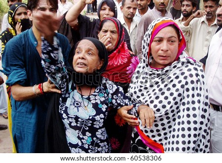 LAHORE, PAKISTAN-SEPT 02: People shout slogans to condemn Wednesday’s blasts during funeral prayer of those, who were lost their life in bomb explosions yesterday, at Nasir Bagh Sept 2, 2010 in Lahore