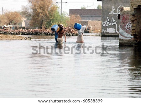 DERA ALLAHYAR, PAKISTAN-SEPT 02: Flood affected men hold cans move in search of drinking water through flood water at a flood hit area on Thursday, September 2, 2010 in Dera Allahyar, Pakistan