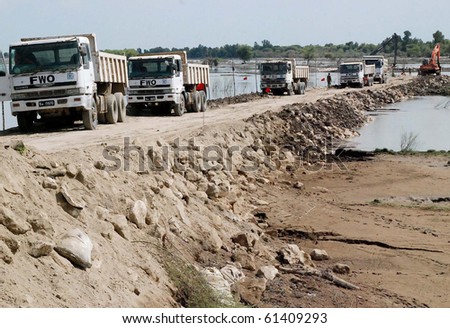 SUKKUR PAKISTAN-SEPT 15: Frontier Works Organization (FWO) workers busy in  repairing of Breach at Tori bund while villages in Sehwan and Johi were flooded. Taken Sept. 15, 2010 in Sukkur, Pakistan.