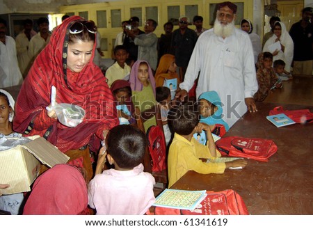 SANGHAR, PAKISTAN-SEPT 16: Sindh Tourism Minister, Shazia Marri distributes gifts among students during her visits at makeshift school established at a flood relief camp Sept 16, 2010 in Sanghar