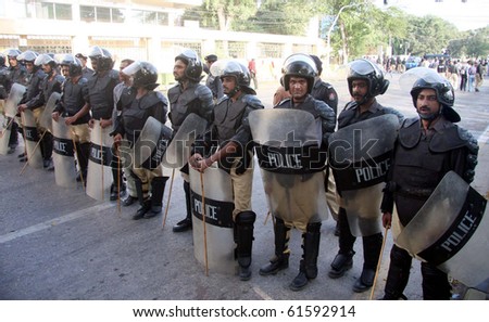 KARACHI, PAKISTAN, SEPT 23: Police officials stand guard at a road that leads towards US Consulate during protest rally of Pasban for the release of Dr.Aafia Siddiqui, September 23, 2010 in Karachi, Pakistan.