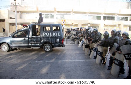 KARACHI, PAKISTAN, SEPT 23: Police officials stand guard at a road that leads towards US Consulate during protest rally of Pasban for the release of Dr.Aafia Siddiqui, in Karachi September 23, 2010 in Karachi, Pakistan.