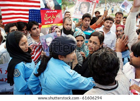 ISLAMABAD, PAKISTAN, SEPT 23: Police officials stop supporters of Defence of Human Rights to move towards US Embassy during their protest rally for the release of Dr.Aafia  Siddiqui, September 23, 2010 in Islamabad, Pakistan