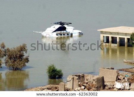 SEWAN, PAKISTAN, OCT 01: World Food Program helicopter stuck in flooded water, which was crashed during rescue work at Flood affected area on October 1, 2010 in Sewan, Pakistan.