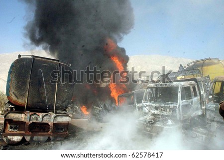 QUETTA, PAKISTAN - OCT 06: Fire flames rise from burning NATO oil tankers following armed attack on October 06, 2010 in Quetta, Pakistan.