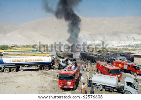 QUETTA, PAKISTAN - OCT 06: Fire tenders gather at the site following armed attack on NATO oil tankers on October 06, 2010 in Quetta, Pakistan