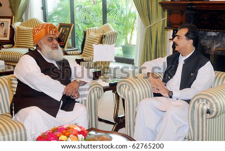 ISLAMABAD, PAKISTAN - OCT 09: Prime Minister, Syed Yousuf Raza Gilani, exchanges views with Jamiat Ulema Islam Mulana Fazlr Rehman during meeting at PM House on October 09, 2010 in Islamabad, Pakistan