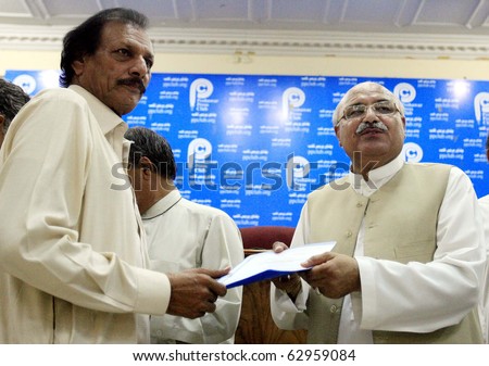 PESHAWAR, PAKISTAN - OCT 12: Khyber Pakhtoonkhawa Information Minister, Mian Iftikhar Hussain, distributes documents of \