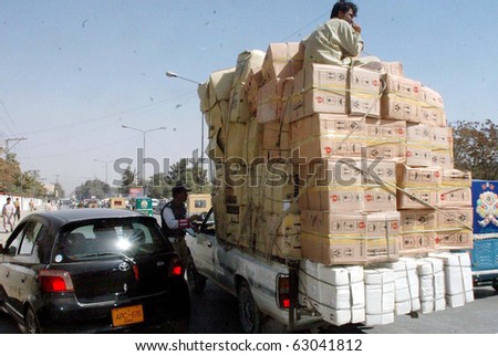 stock-photo-quetta-pakistan-oct-traffic-police-official-does-chalan-of-an-overloaded-truck-on-october-63041812.jpg