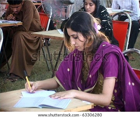 LARKANA, PAKISTAN - OCT 17: Students solve papers during entry test for the admission in first year \
