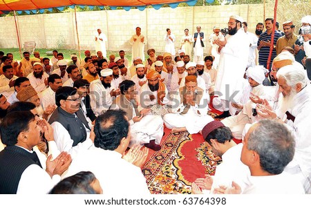 CHOTI ZAREEN, PAKISTAN - OCT 23: Muslim League-Q leader, Ch.Pervez Elahi, along with other offers Dua (pray) for former President, Farooq Ahmed Khan Leghari on October 23, 2010 in Choti Zareen.
