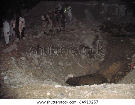 KARACHI, PAKISTAN - NOV 11: People gather at the debris of Crime Investigation Department building which was destroyed in explosion, after explosion on November 11, 2010 in Karachi, Pakistan.