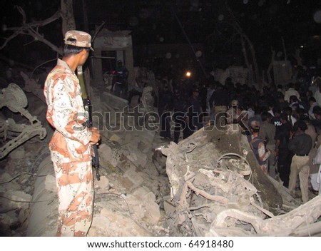 KARACHI, PAKISTAN - NOV 11: People gather at the debris of Crime Investigation Department building which was destroyed in explosion, after explosion on November 11, 2010 in Karachi, Pakistan.