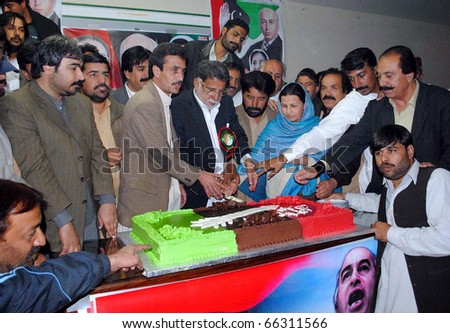 QUETTA, PAKISTAN - NOV 30: Peoples Party leader and activists cuts cake during ceremony on occasion of the PPP Forty-fourth Youm-e-Tasees (Foundation Day) held on November 30, 2010 in Quetta.