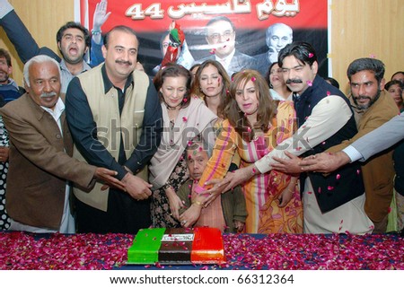 ISLAMABAD, PAKISTAN - NOV 30: Peoples Party leaders cut cake during ceremony on occasion of the Peoples Party (PPP) Forty-fourth Youm-e-Tasees held on November 30, 2010 in Islamabad.