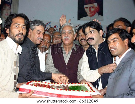 ISLAMABAD, PAKISTAN - NOV 30: Activists of Peoples Party cut cake during  ceremony on occasion of the PPP Forty-fourth Youm-e-Tasees (Foundation Day) held on November 30, 2010 in Islamabad.