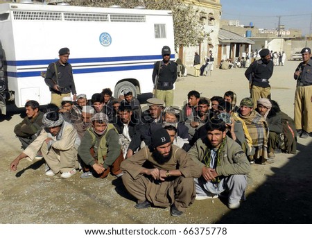 CHAMAN, PAKISTAN - DEC 01: Police officials show arrested afghan nationals who were crossed into the Country from Afghanistan without legal documents on December 01, 2010 in Chaman, Pakistan.