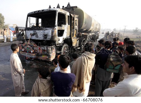 PESHAWAR PAKISTAN - DEC 06: Peoples gathers near a burnt Oil tanker after unidentified gunmen set on fire on December 06, 2010 in Peshawar, Pakistan.