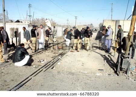 QUETTA, PAKISTAN - DEC 07: Police officials inspect the site following attack on convoy of the Balochistan Chief Minister on December 07, 2010 in Quetta, Pakistan.