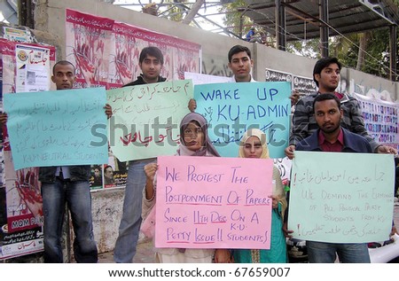 KARACHI, PAKISTAN - DEC 21: Karachi University (KU) students hold placards as they are protesting in favor of their demands on December 21, 2010 in Karachi, Pakistan.
