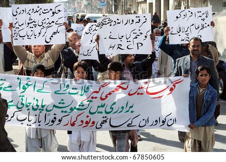 QUETTA, PAKISTAN - DEC 26: Supporters of Human Rights Commission (HRCP) pass through a road during protest rally against lawlessness and in favor of their demands on December 26, 2010 in Quetta.