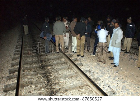 HYDERABAD, PAKISTAN - DEC 26: Bomb disposal squad officials inspect railway track after information of bomb on track at Qasimabad area on December 26, 2010 In Hyderabad.