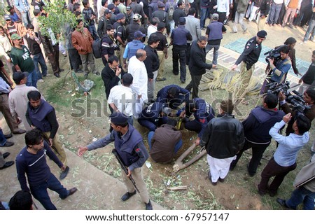 KARACHI, PAKISTAN - DEC 28: Bomb disposal squad officials inspect crater at the site of explosion on December 28, 2010 in Karachi.