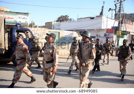 KARACHI, PAKISTAN - JAN 13: Rangers and police officials busy in search operation against criminals after clash between two groups at Pehelwan Goth on January 13, 2011in Karachi.