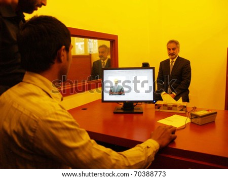 KARACHI, PAKISTAN - FEB 02: Sindh Home Minister, Zulfiqar Mirza, poses for picture of computerized arms license after inauguration of computerized arms license office on February 02, 2011in Karachi.