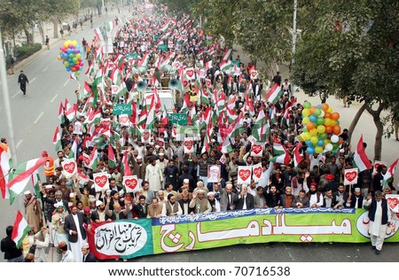 LAHORE, PAKISTAN - FEB 6: Supporters of Tehreek Minhaj-ul-Quran pass through Mall Road during Milad March on February 06, 2011in Lahore Pakistan