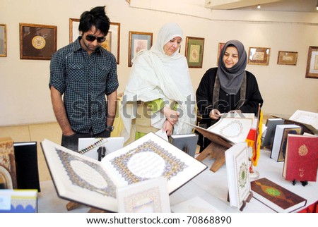 LAHORE, PAKISTAM - FEB 06: People take keen interest at a stall during handicraft exhibition organized by Khana-e-Farhang Iran held at Al-Hamra Hall on February 09, 2011in Lahore.