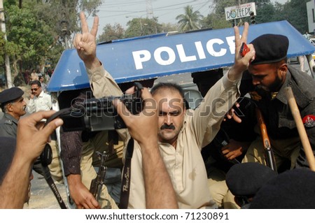 KARACHI, PAKISTAN - FEB 14: Police officials arrest protesters during protest demonstration of residents of Horizon Plaza against Land Mafia at Sharah-e-Faisal on February 14, 2011in Karachi.