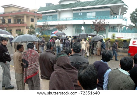 ISLAMABAD, PAKISTAN - MAR 02: People gather at the site where Federal Minister for Religious Affairs Shahbaz Bhatti was gunned down by unidentified gunmen on March 02, 2011in Islamabad.