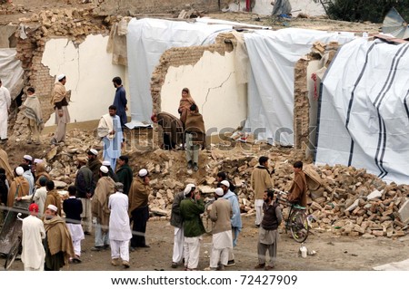 HANGU, PAKISTAN - MAR 03: People look damaged houses which were destroyed by explosion after suicide attack on  March 03, 2011in Hangu.