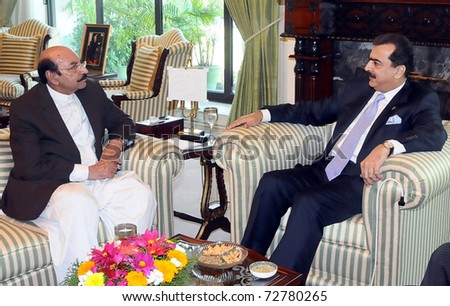 ISLAMABAD, PAKISTAN - MAR 08: Prime Minister, Syed Yousuf Raza Gilani, exchanges views with Sindh Chief Minister, Syed Qaim Ali Shah during meeting at PM House on March 08, 2011in Islamabad.