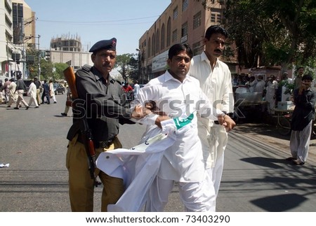 KARACHI, PAKISTAN - MAR 17: Policemen escort a protester after his arrest during protest rally of All Sindh Lower Staff Association in favor of their demands  on March 17, 2011 in Karachi.