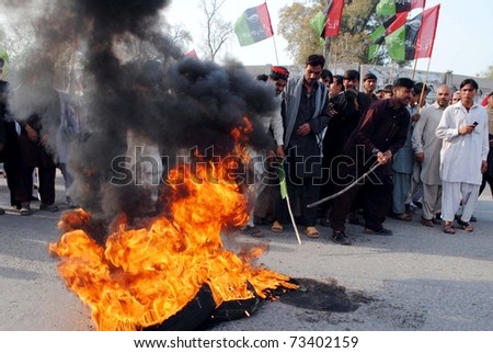 PESHAWAR, PAKISTAN - MAR 17: Activists of Peoples Party-Sherpao burn tires as they are protesting against release of Raymond Davis on March 17, 2011 in Peshawar.