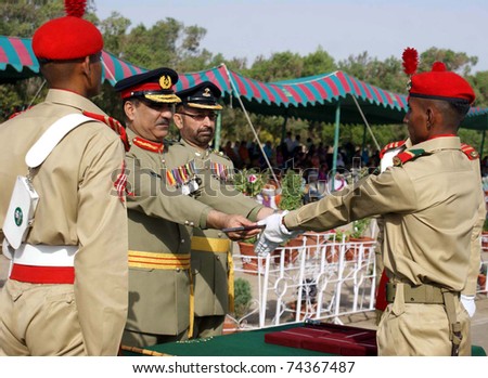 HYDERABAD, PAKISTAN - MAR 31: Sindh Regimental Center Commandant, Brig.Hamid Abdullah gives away prize award to best recruits during a passing out parade held at SRC on March 31, 2011in Hyderabad, Pakistan.