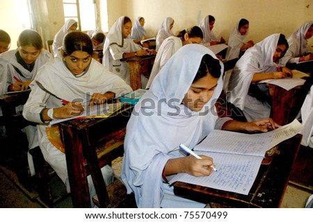 SUKKUR, PAKISTAN - APR 18: Students solve papers at an examination hall during Annual Matriculation Examination 2011on April 18, 2011 in Sukkur .