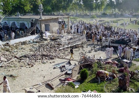 CHARSADDA, PAKISTAN - MAY 02: People gather at the site of explosion after bomb explosion on May 02, 2011 in District Charsadda, Pakistan.