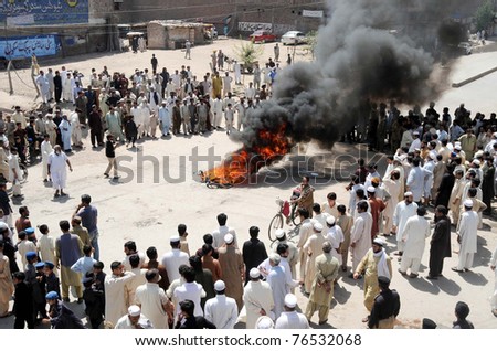 PESHAWAR, PAKISTAN - MAY 03: Angry protesters burn tyres during protest demonstration of Tajir Insaf against electricity load-shedding at Lahori Gate on May 3, 2011 in Peshawar, Pakistan