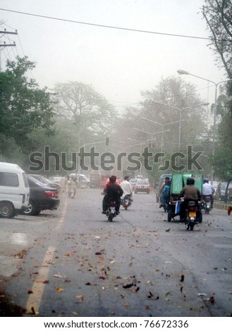 LAHORE, PAKISTAN - MAY 05: Commuters pass through street during dust storm on May 05, 2011in Lahore, Pakistan
