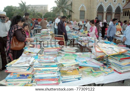 KARACHI, PAKISTAN - MAY 15: People buy books at different stalls during Kutub (books) Bazaar at city district government historical park Frere Hall on May 15, 2011 in Karachi.