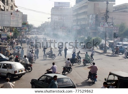 KARACHI, PAKISTAN - MAY 18: Angry residents stop motorists to move forward as they are protesting against electricity load-shedding in their area on Wednesday, May 18, 2011 in Karachi.
