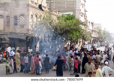 KARACHI, PAKISTAN - MAY 25: Angry protesters burn garbage at a road during protest demonstration of residents against electricity load-shedding in area on May 25, 2011 in Karachi.