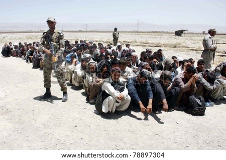 CHAMAN, PAKISTAN - JUN 08: Security officials show arrested afghans who were captured when they were entering the country through Garang check post in the mountains Kojak on June 08, 2011in Chaman.